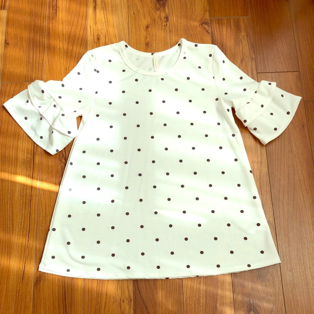 Ruffle sleeve polka dot shirt.